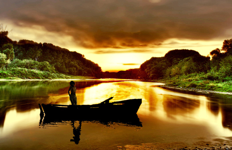 Woman in boot by sunset von Woman in boot by sunset