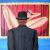 Man with bowler in front of nude von Bela Manson